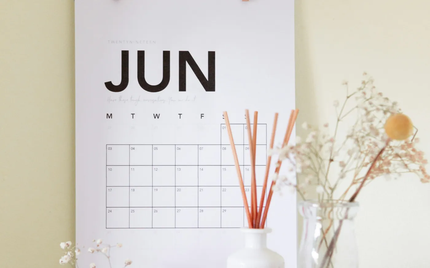 vase on book near calendar by Maddi Bazzocco courtesy of Unsplash.