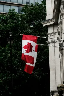 Canada flags by Paul Fiedler courtesy of Unsplash.