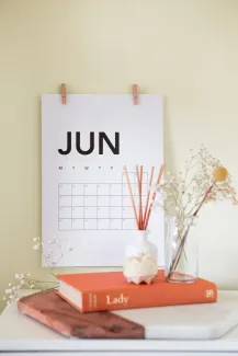 vase on book near calendar by Maddi Bazzocco courtesy of Unsplash.
