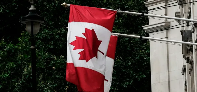 Canada flags by Paul Fiedler courtesy of Unsplash.